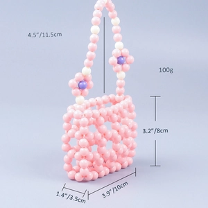 Detail showing dimensions of pink beaded mini bag with floral handle and hollow grid design