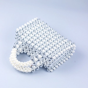 Detail of handcrafted square tote bag with silver electroplated and pearl beads