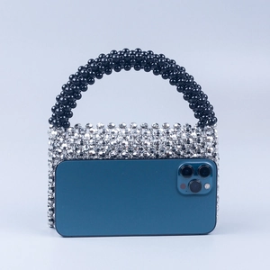 Mini rectangular handmade beaded handbag in black and silver with phone size reference