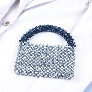 Detail of handmade beaded handbag with silver metallic faceted beads and black handles