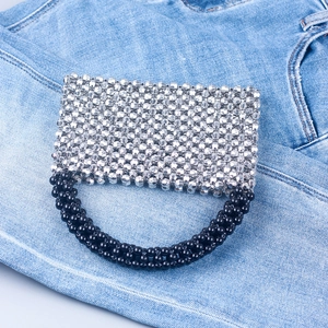 Handmade beaded rectangular handbag featuring silver acrylic beads and black woven handle