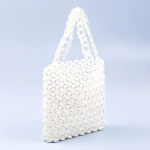 Handmade white pearl beaded handbag with floral pattern in elegant trapezoid shape