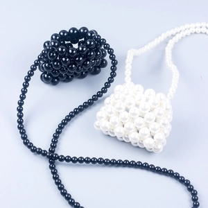 Handmade beaded mini lipstick bag in black and white woven design for summer fashion