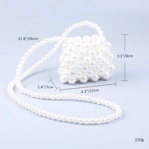 Detail view of mini beaded crossbody bag with white faux pearls and size annotations