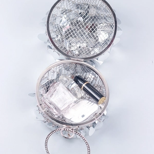 Silver spherical hollow evening clutch bag with sequins, ring handle and rhinestones