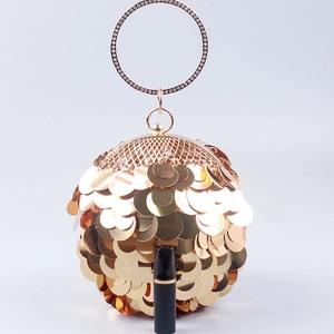 Golden sequin spherical evening bag with rhinestone handle and lipstick for scale
