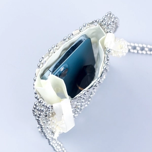 Handmade silver acrylic floral beaded crossbody bag with a sleek woven finish