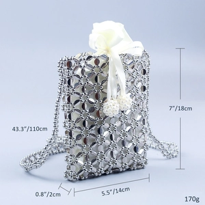 Detail of silver acrylic flower bead crossbody bag with white satin drawstring closure