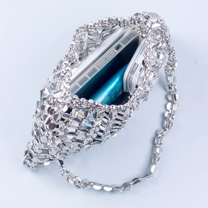 Handmade silver sequined evening handbag with metal chain showing storage capacity