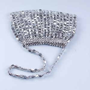 Macro shot of silver metal sequins and ring connectors on a handmade shoulder bag