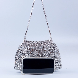 Detailed view of silver sequin woven tote bag with chain strap and size reference