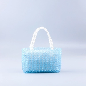 Handmade woven acrylic blue beaded handbag with white pearl handles in a square shape