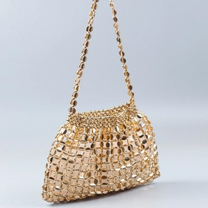 Detail of hand-woven gold metallic disc evening bag with polished finish and mesh structure