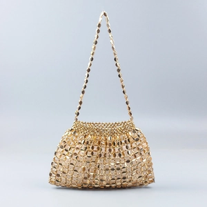 Detailed view of handmade gold beaded woven dumpling bag with metallic texture and chain