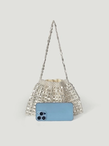 Detail of hand-woven beaded hobo bag with white satin lining and phone for scale