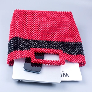 Handmade red and black beaded handbag showing spacious interior with daily essentials