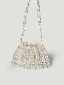 Detail of silver disc chainmail handbag with pearl trim and satin drawstring pouch