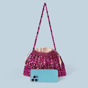 Detailed view of magenta beaded tote bag with satin drawstring liner and smartphone for scale