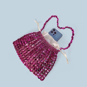 Detail of rose red beaded handbag with internal drawstring pouch and phone for scale