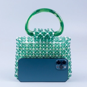 Green acrylic beaded tote bag with white pearl accents and D-shaped handle