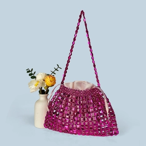 Detail of rose red beaded handbag with pink satin drawstring lining and woven beads