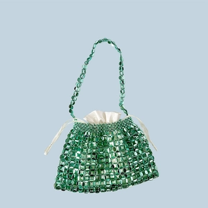 Detail of emerald green beaded evening bag with luxury satin drawstring inner lining