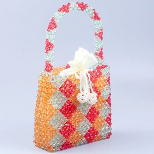 Handmade beaded handbag with red orange green diamond pattern and drawstring liner