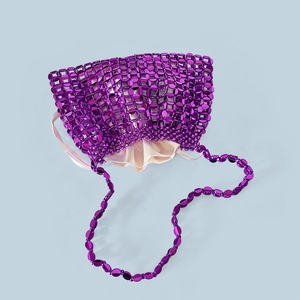 Detail of purple metallic sequin woven handbag with satin drawstring lining and beaded strap