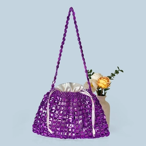 Detail of purple beaded dumpling bag with satin drawstring liner and woven bead handle