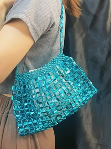 Detail of blue sequin woven shoulder bag showing shimmering circular metallic discs