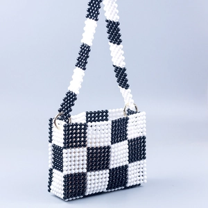 Handmade checkered beaded handbag with black and white pearls and long shoulder strap