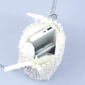 Mini pearl woven bucket bag with silk drawstring lining and silver metal chain strap