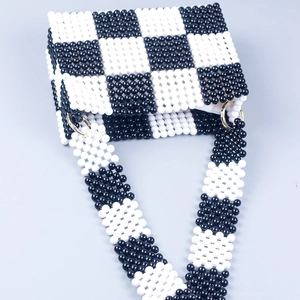 Handmade checkered beaded shoulder bag in black and white with gold metal rings