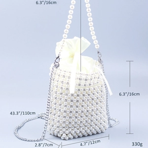 Detail of handmade faux pearl and rhinestone clutch with satin drawstring inner bag