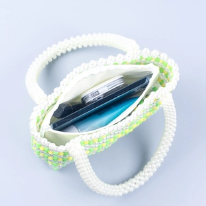 Handmade woven bead handbag with green yellow and white patterns and pearl handle