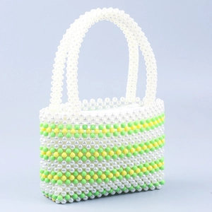 Detail of handmade green and white striped acrylic beaded handbag with top handles