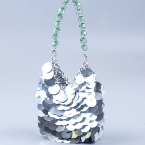 Silver sequin dinner bag with green beaded handle for party and evening events