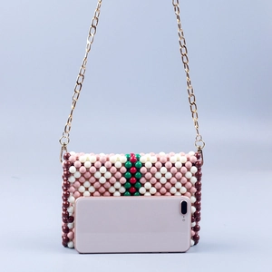 Handmade beaded crossbody bag with colorful stripes and golden chain shoulder strap