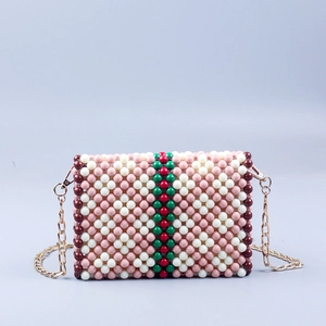 Elegant handmade floral beaded crossbody bag with pink accents and chain strap