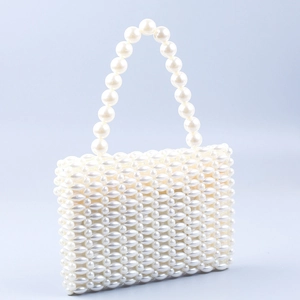 Elegant white faux pearl beaded handbag with woven texture and a rounded top handle