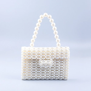 Macro detail of hand-woven faux pearl texture and elegant buckle on the white handbag