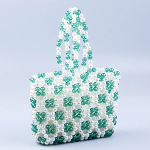 Handmade beaded handbag with green and white floral pattern and short top handle