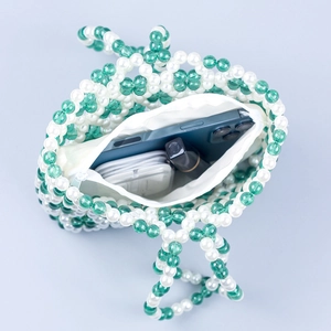 Handmade beaded handbag in green and white featuring a functional zipper inner lining