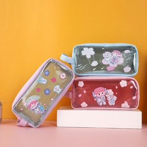 Detail of cute transparent PVC pencil case with glitter finish and cartoon patterns