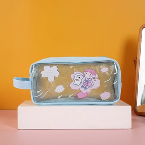 Detail of blue pencil case showing cartoon illustration and transparent PVC window