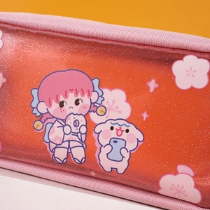 Detail of glitter orange pencil case with cute anime girl and dog illustration