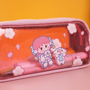 Close-up of pink glitter transparent pencil case with cute cartoon girl and cherry blossoms