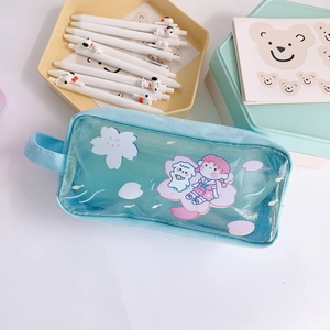 Macro view of blue translucent pencil case with cute anime girl and sakura floral patterns