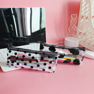 Transparent large capacity PVC pencil case with polka dots and zipper on pink desk