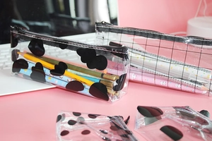 Detail of transparent PVC pencil case with cloud patterns and smooth zipper closure